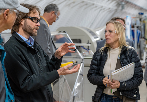 Three people talking in a lab.