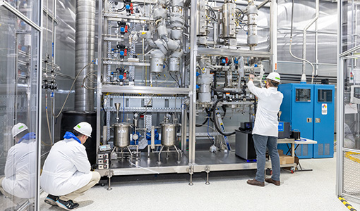 Continue reading about Two people in PPE work in a lab.