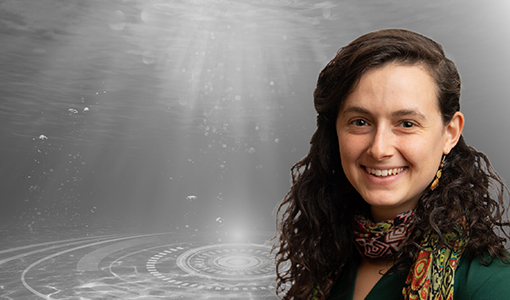 Continue reading about A person wearing a scarf smiling with an underwater graphic behind them.