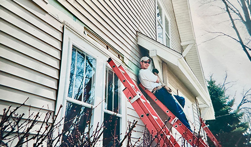 Continue reading about A person stands on a ladder leaning against a house.