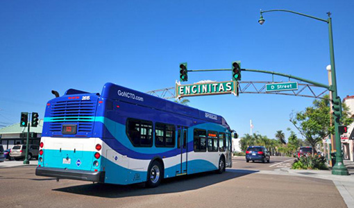 Continue reading about A bus drives under a sign that reads Encinitas.
