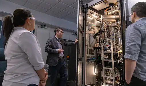 Continue reading about Researchers view an autonomous electron microscope in the basement of the Solar Energy Research Facility at NREL.