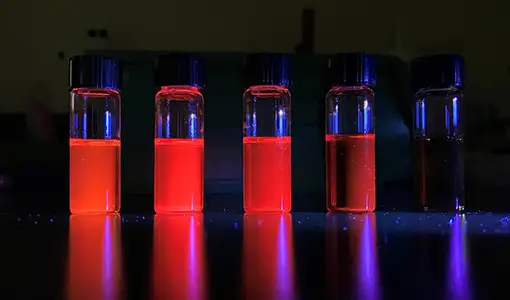 Continue reading about Image of five vials with glowing liquid inside.
