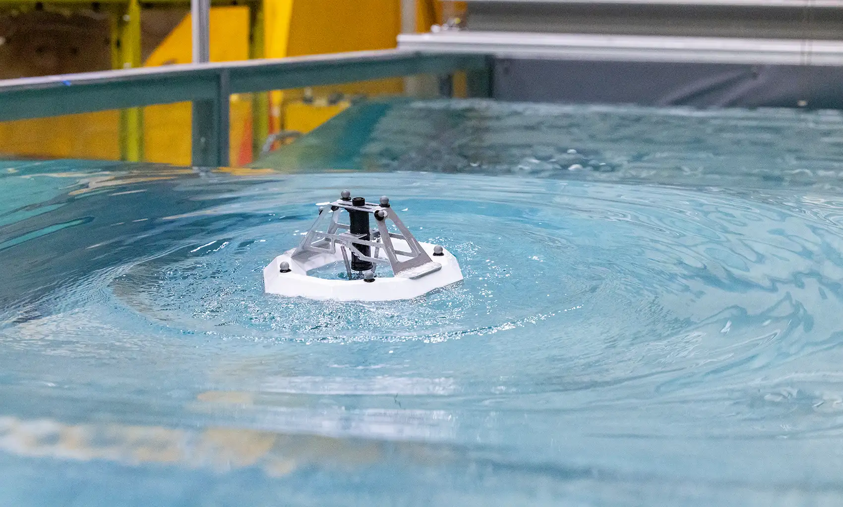 A tank-test model floats on the surface of a tank of water.