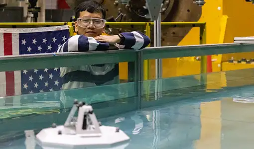 Continue reading about A person standing near a tank of water.