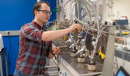 Continue reading about A scientist works with a reactor.