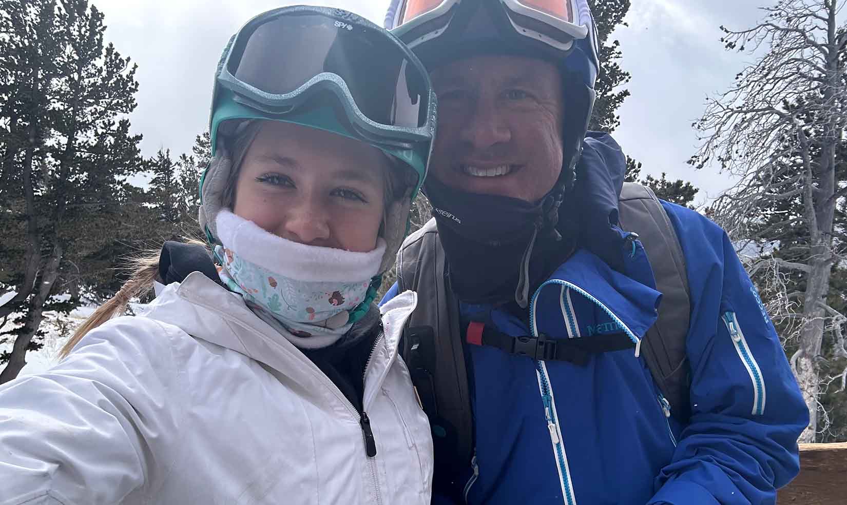 Ringer and his teenage daughter wearing ski helmets and goggles