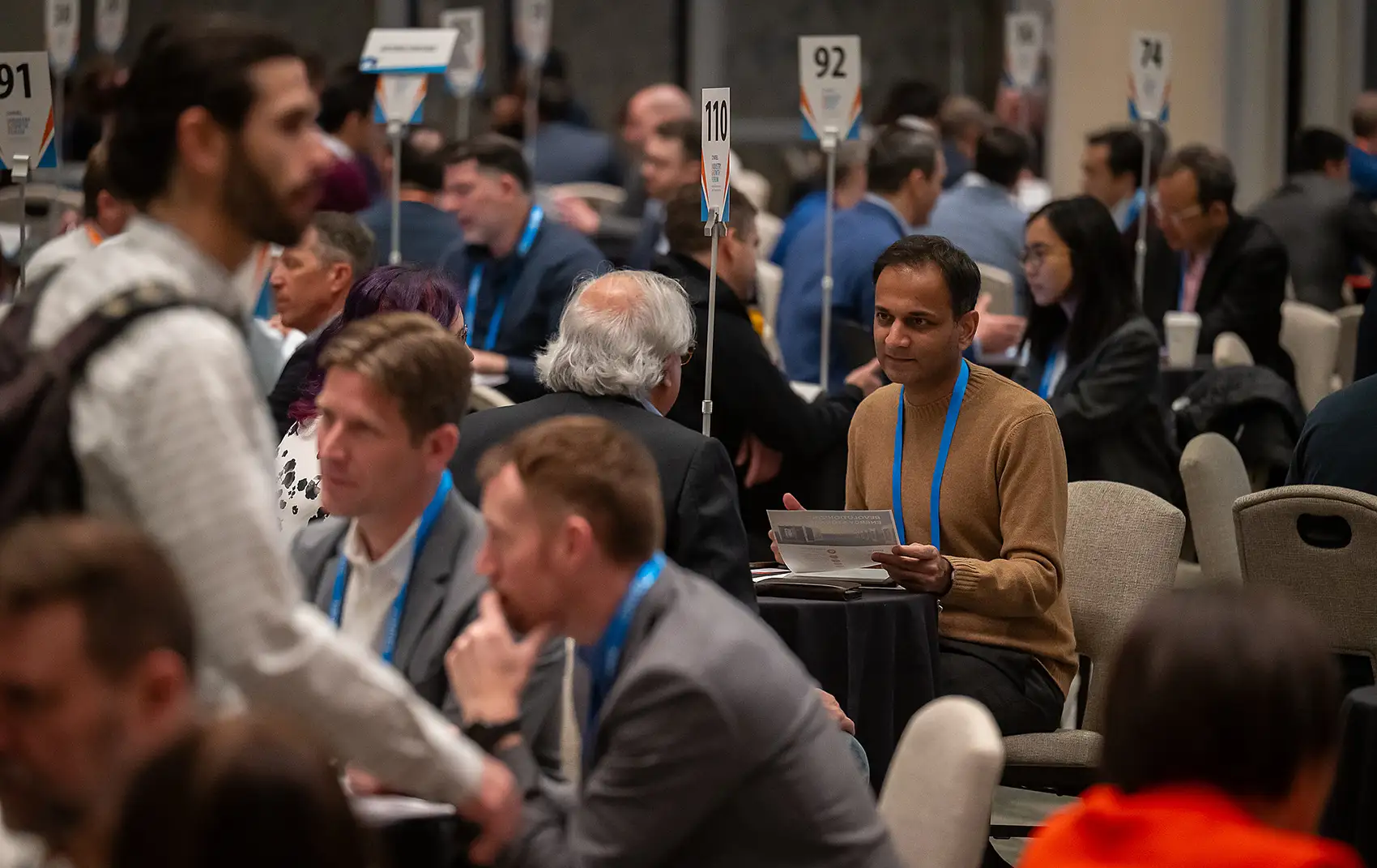 A room full of people sitting at tables.