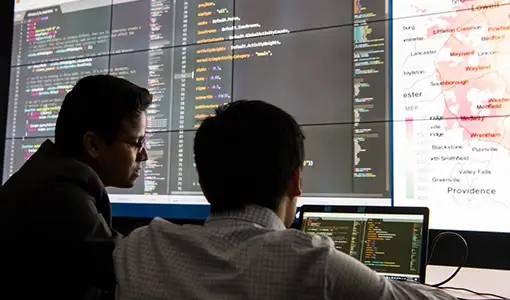 Continue reading about Photo of two people looking at large-screen display of data and analysis results.