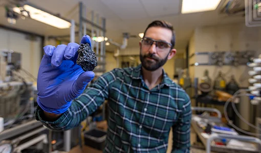 Continue reading about A researcher holds a chunk of bio-coke.