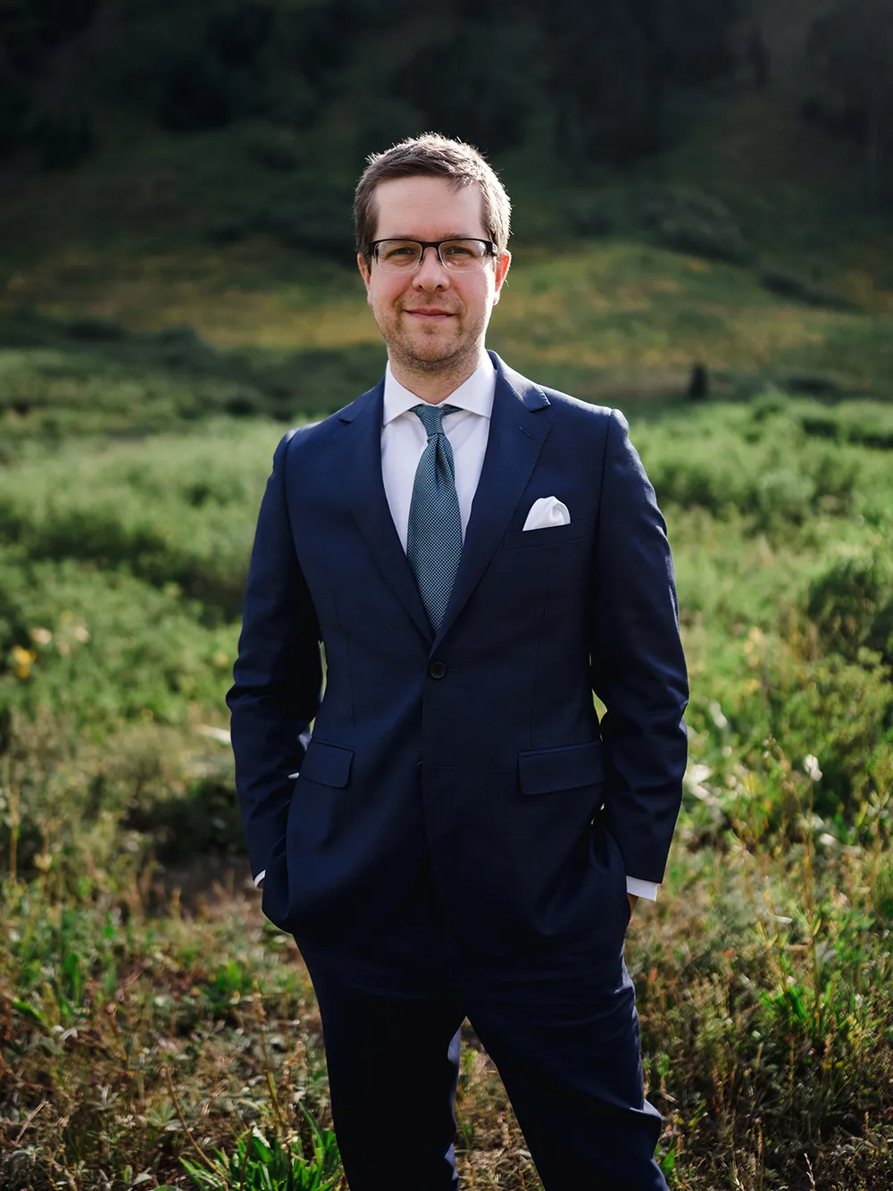 A man wearing a suit standing outside