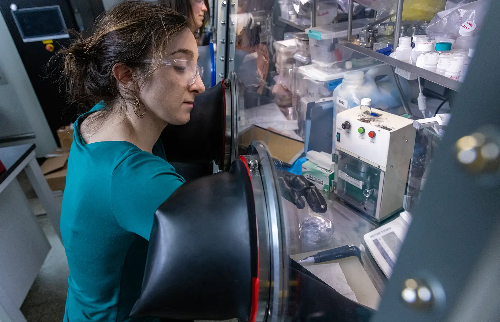 A person using a glovebox.