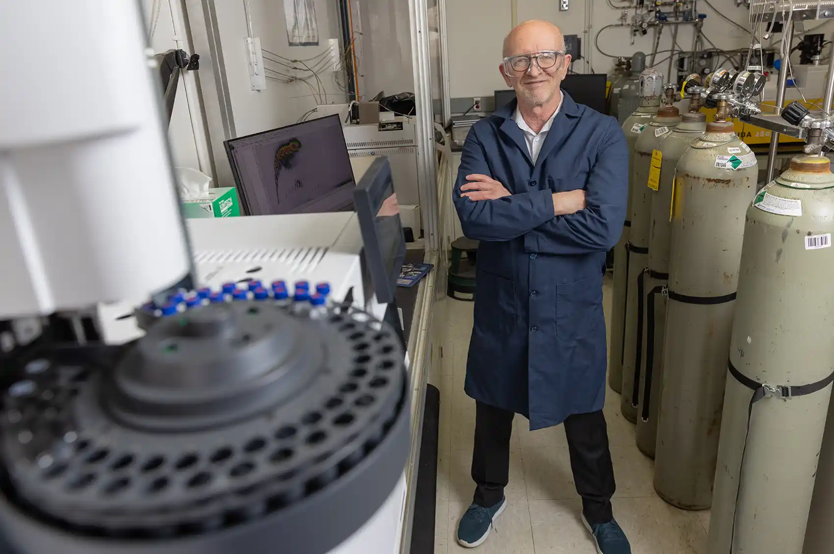 20260723-as-jet-fuel-supplies-tighten-can-other-fuels-meet-demand-104249 A person stands with their arms crossed next to a 2D gas chromatograph coupled to a time-of-flight mass spectrometer