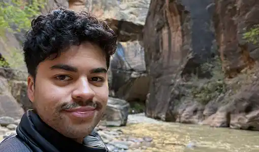 Continue reading about Portrait of Patrick Emami hiking.