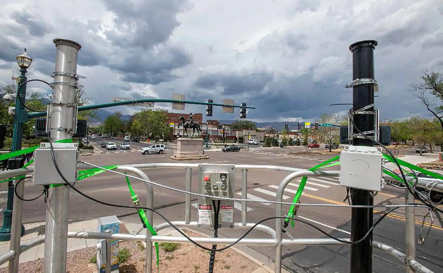 Scientific equipment attached to poles near intersection.