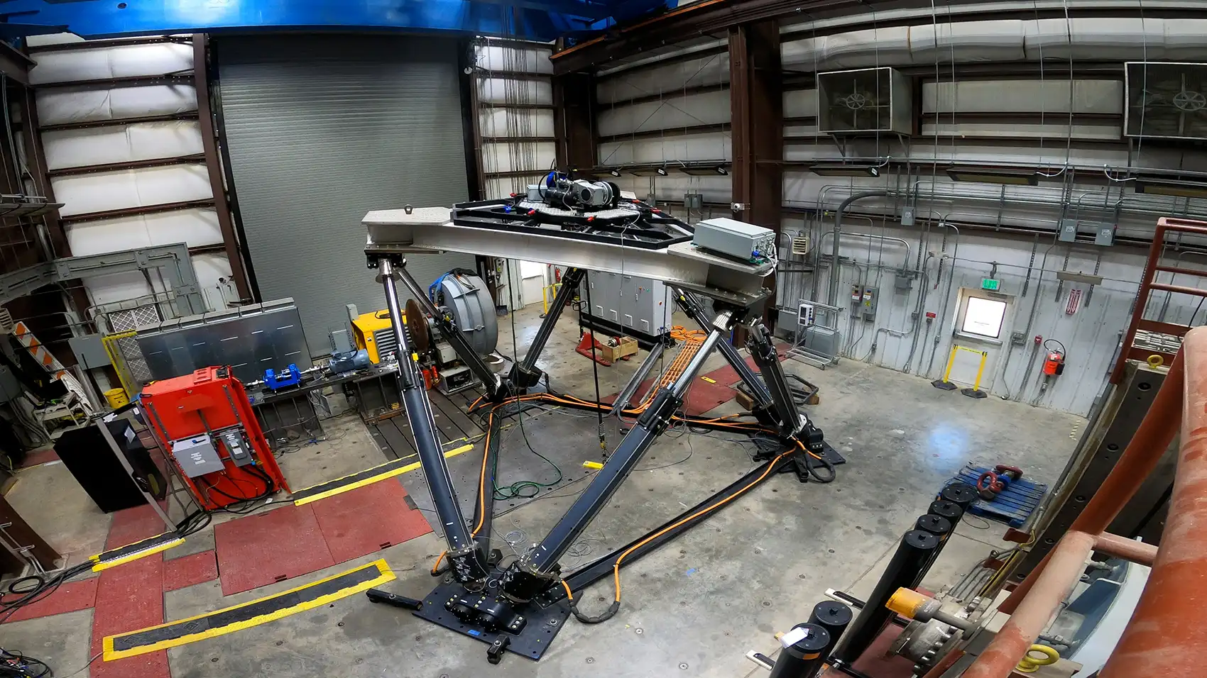 20260909-pacwave-opens-a-giant-leap-for-marine-energy-097852 Machinery being tested in a laboratory warehouse.