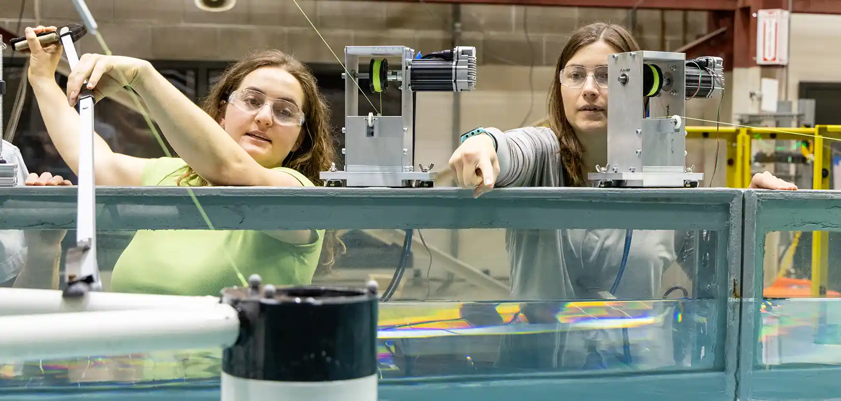 Nora and Hannah Ross testing a floating marine turbine platform in the NLR Sea Wave Environmental Lab.