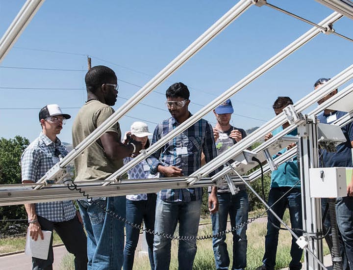 Students inspect a PV structure.