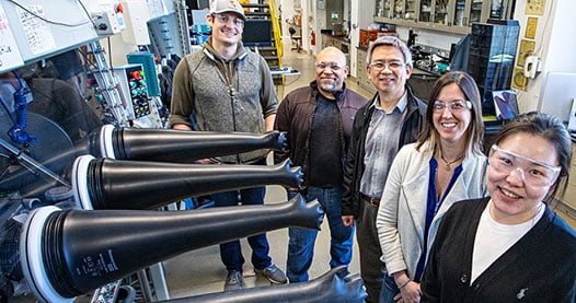 four researchers in a lab