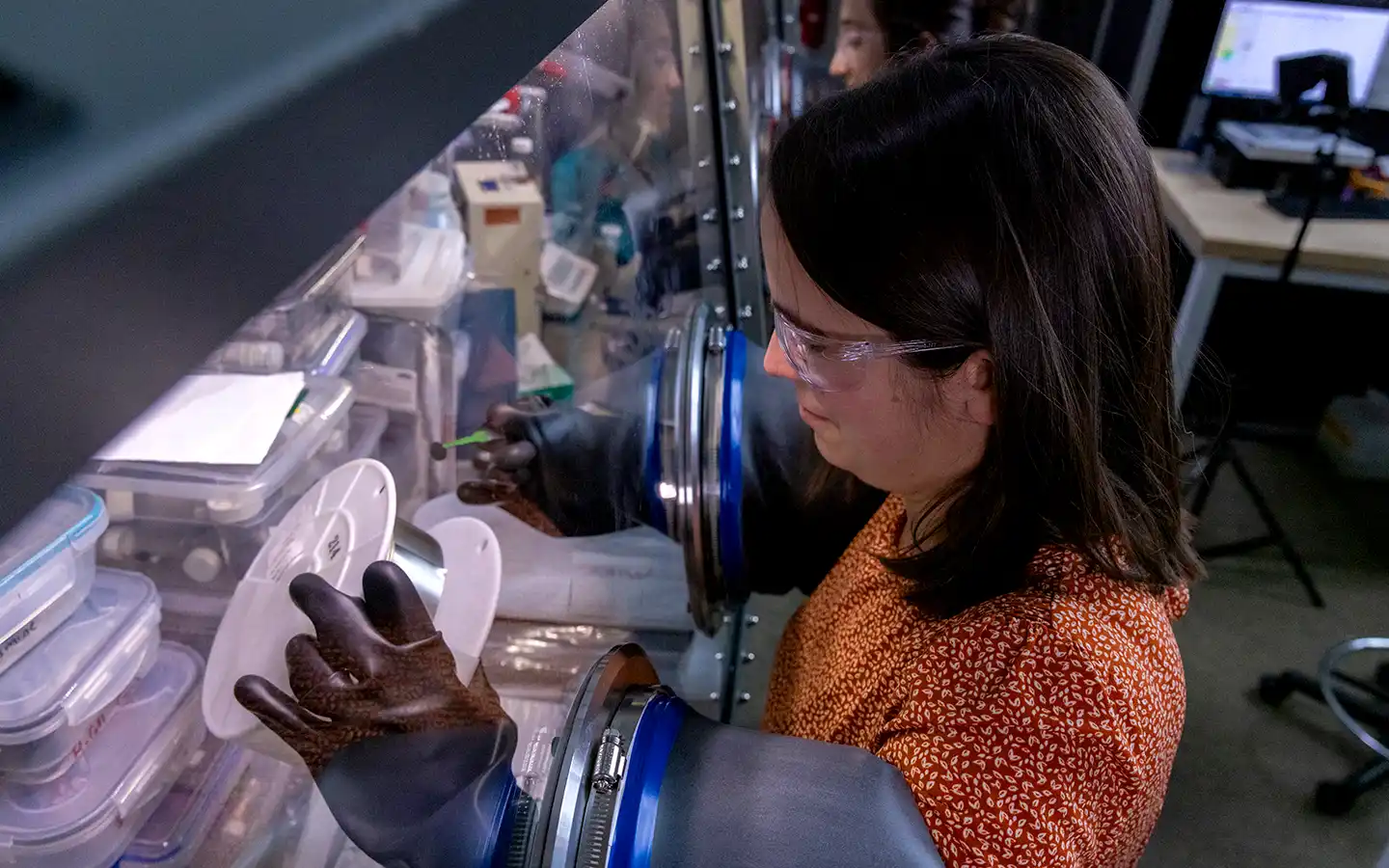 Researcher works in a glovebox.