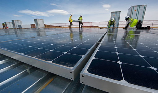Workers installing solar rooftop panels.