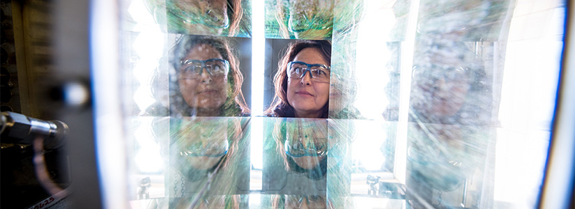 A researcher looking through illuminated solar optics.