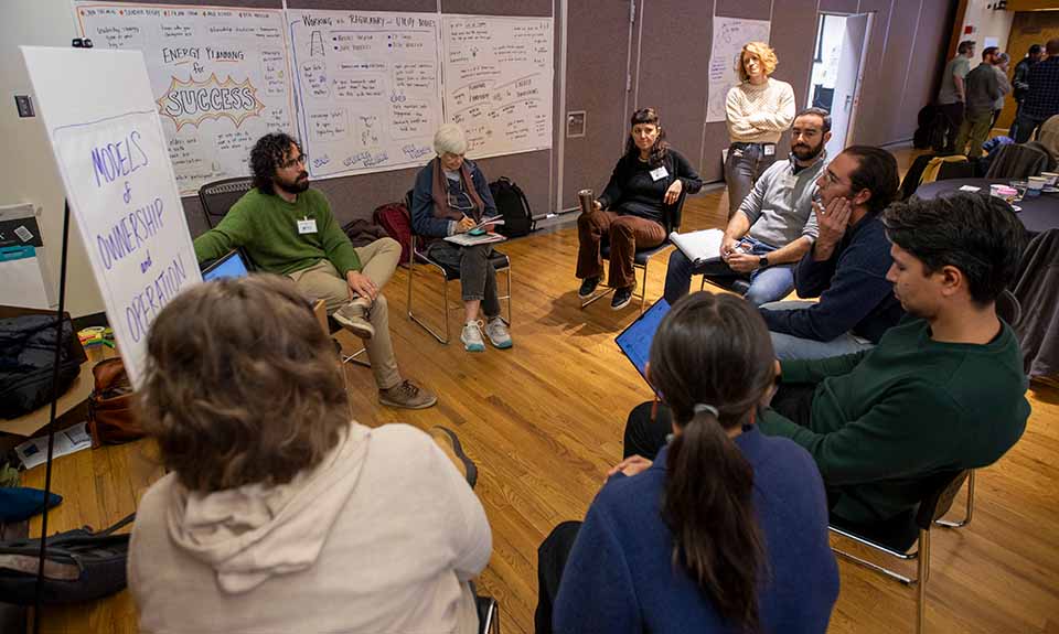 A group of people sitting in a small circle.