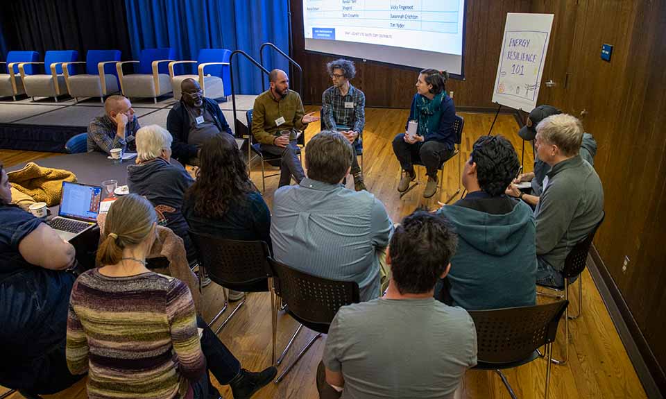 A group of people sitting in a circle.