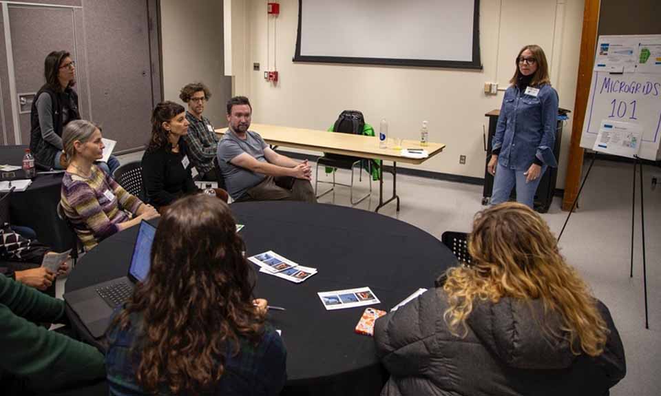A woman speaking to a group of people.
