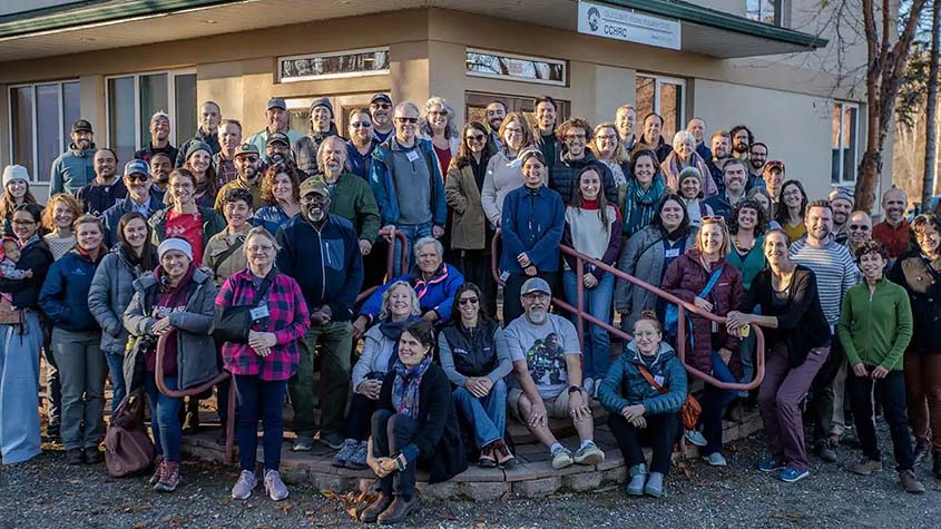 A group of people standing outside.