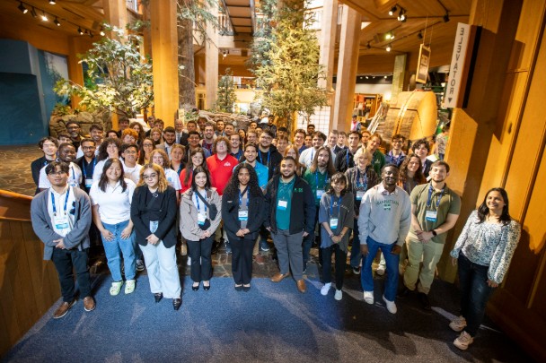 Group of students stand inside lobby