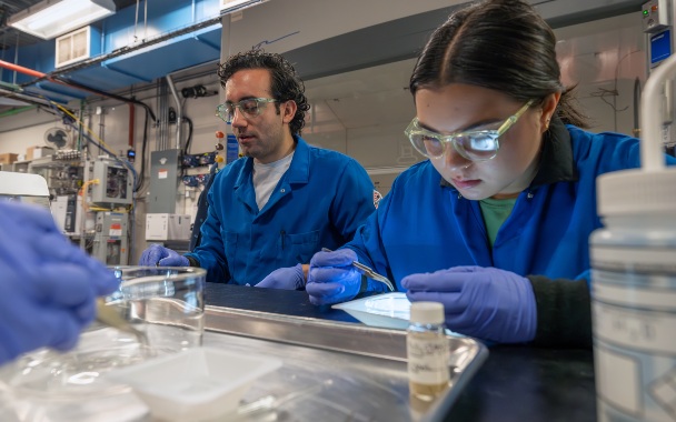 Two people study waterborne plastics