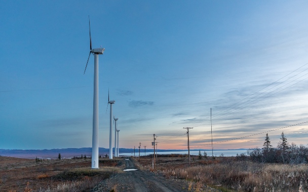 Wind turbines line the ocean's edge