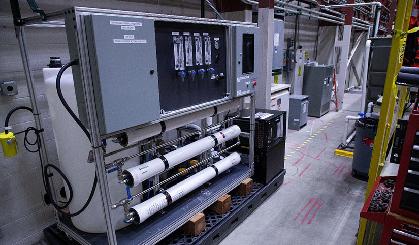 A water tank and electrical control board equipment in a laboratory.
