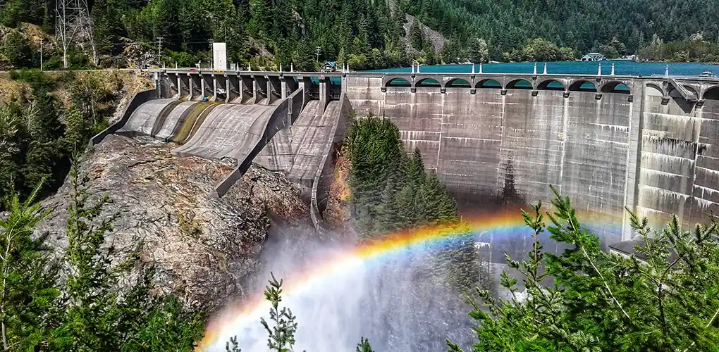 Hydropower dam with a rainbow in front.