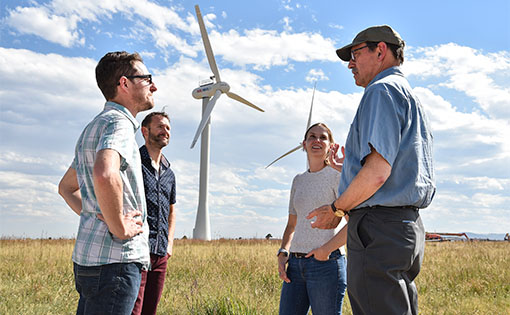 Researchers chatting outside at NREL’s Flatirons campus.