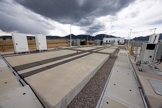 A site with large concrete pads, power converters, charging infrastructure, and more.