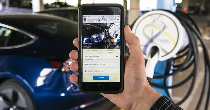 A hand holding up a mobile device.