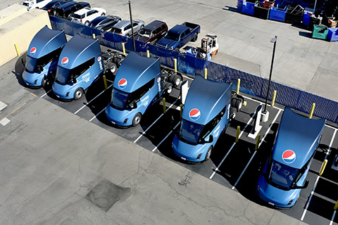A line of trucks with trailers.
