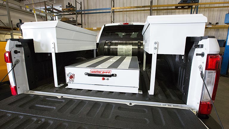 Photo of a compressed natural gas fuel tank located in the bed of a pickup truck that was converted from gasoline to CNG