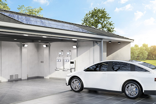 White car plugged in to a charger in a garage with solar panels.