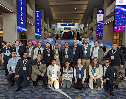 Photo of group of people in crowded conference hall.